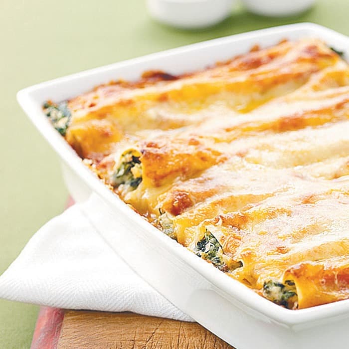 Rolled savoury crepes baked under melted cheese
